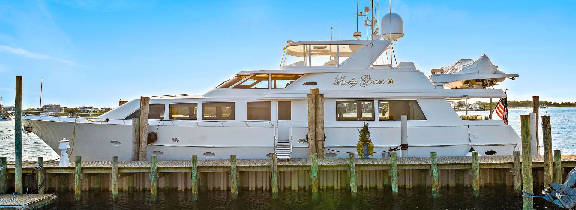 White yacht named Lady Grace docked in a marina