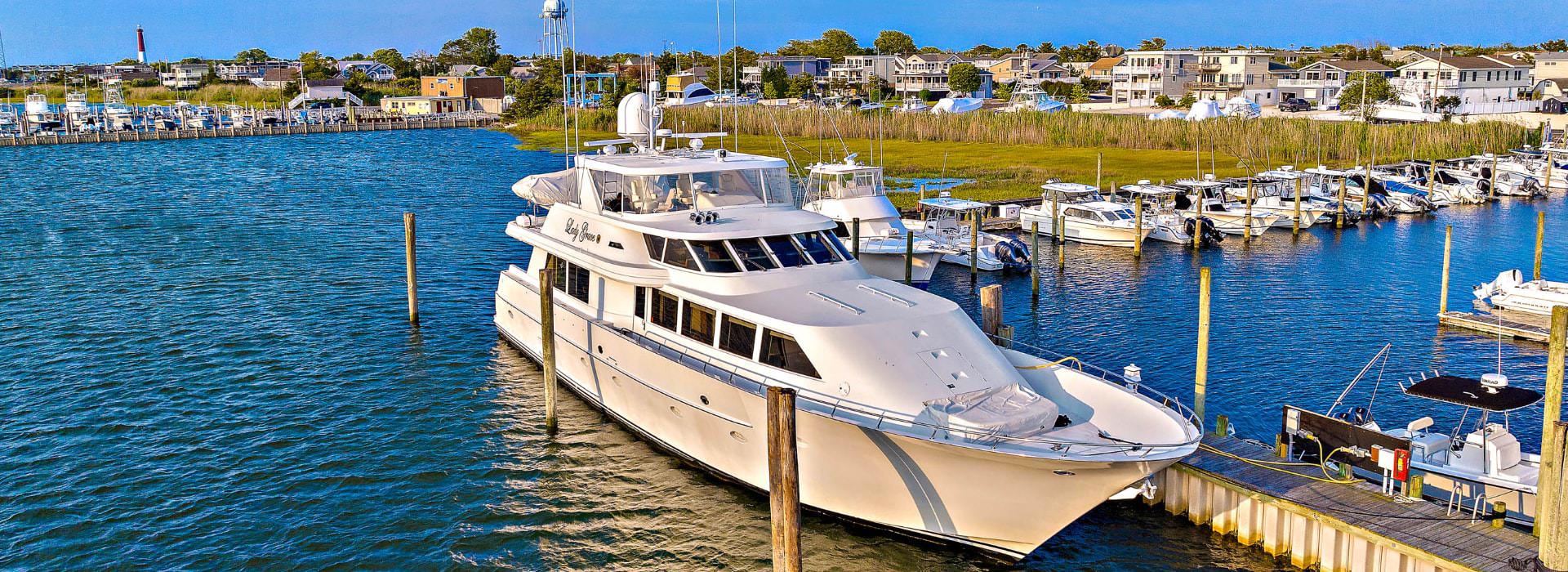 White yacht named Lady Grace docked in a marina
