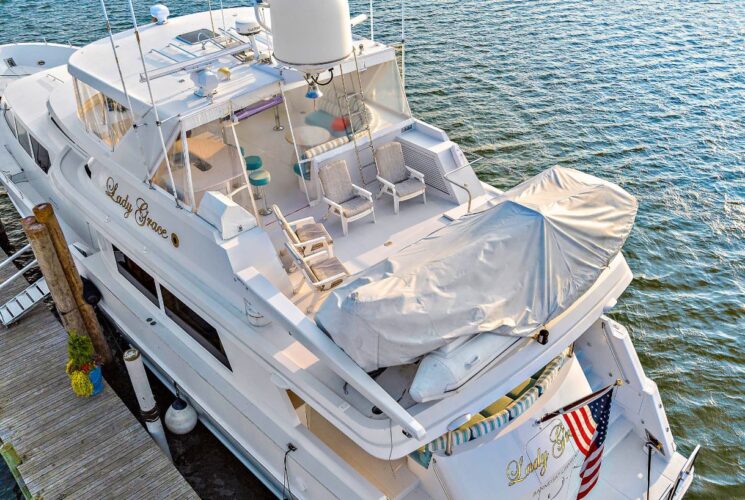 Sun deck of white yacht named Lady Grace docked in a marina