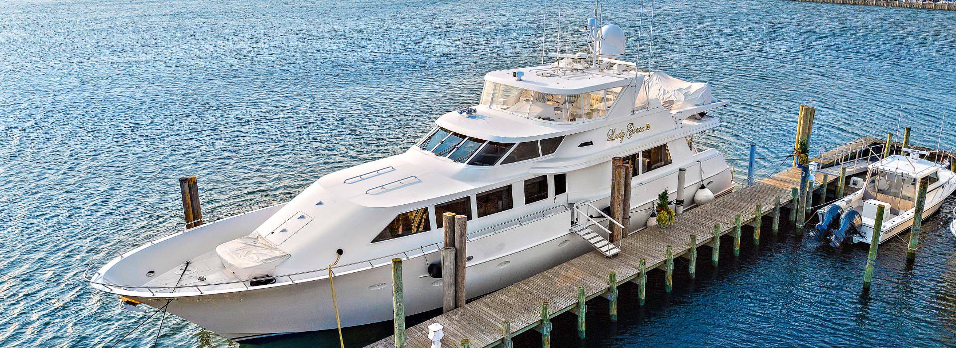 White yacht named Lady Grace docked in a marina