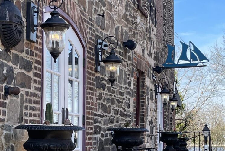Historical stone and brick building with antique wrought iron hanging lanterns